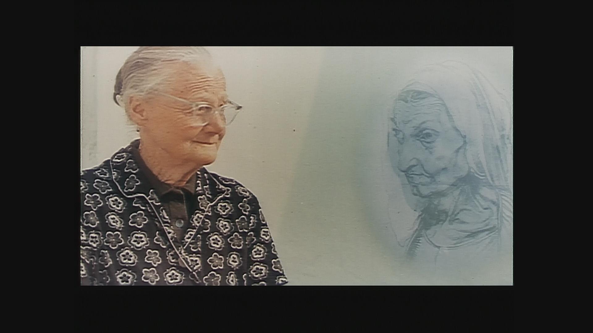 Eine alte Frau mit Brille und eng zurückgebundenem weißen Haar sitzt links im Bild und blickt zur rechten Seite. Dort wird eine Zeichnung eingeblendet: das Porträt einer alten Frau. Die beiden (Frau und Zeichnung) schauen sich an.