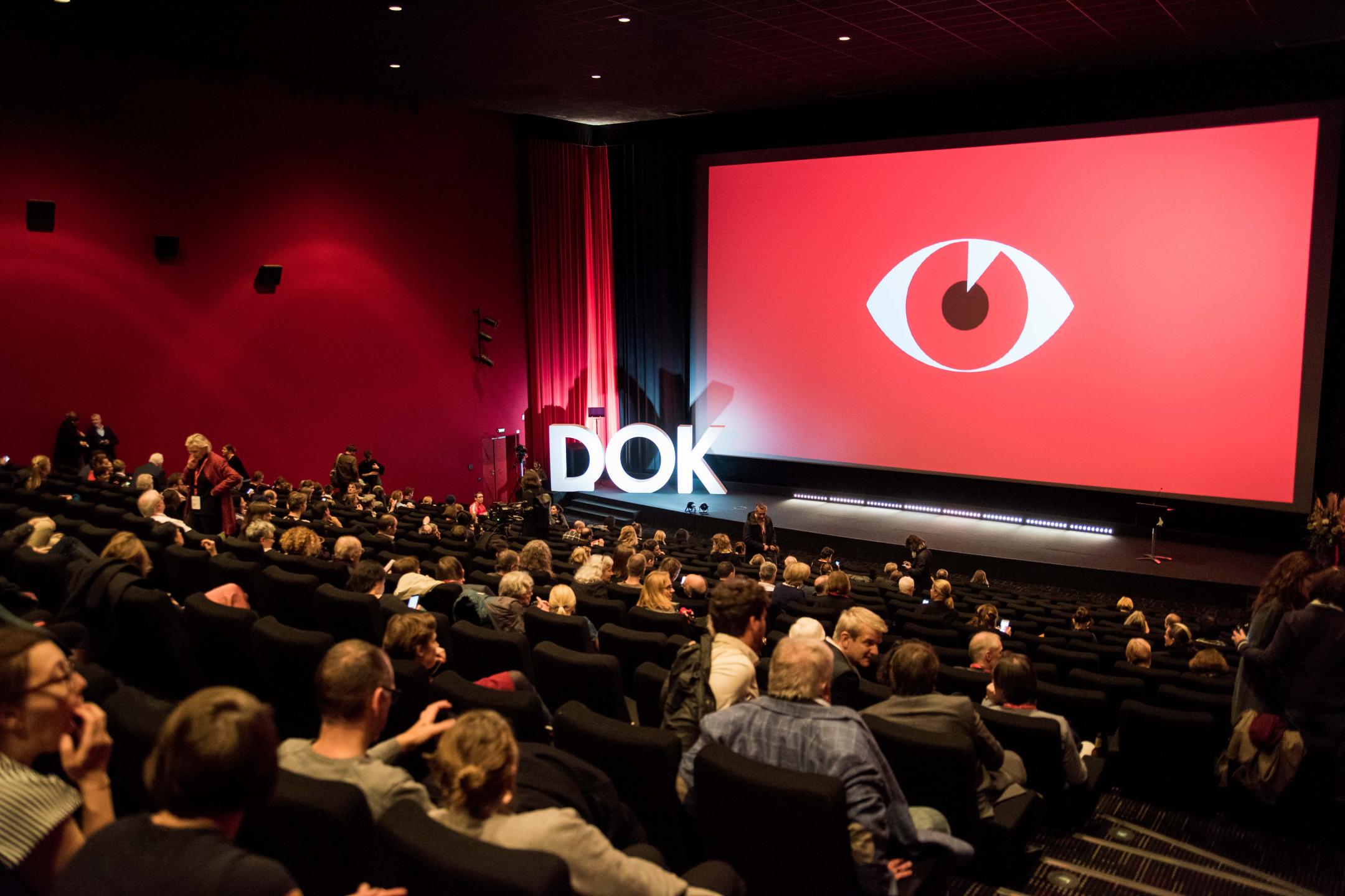 Full cinema with the red festival motive at the DOK Leipzig opening event in the CineStar