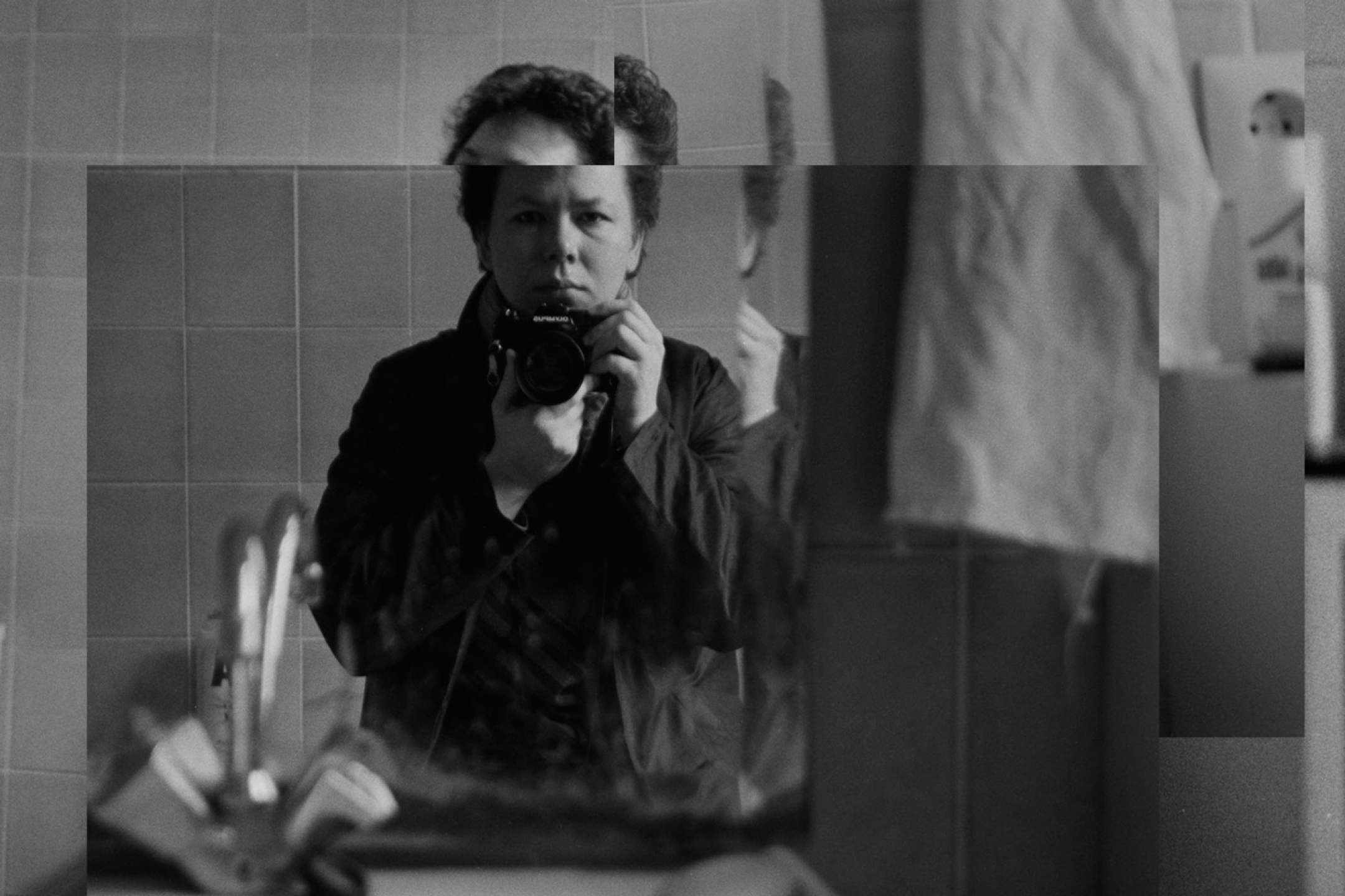 A woman takes a selfie in the bathroom mirror.