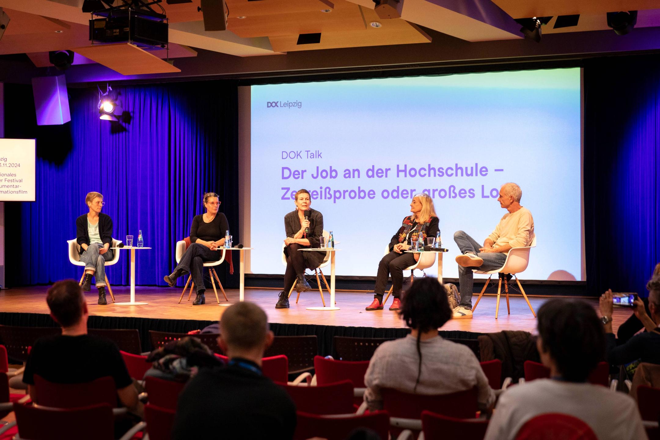A photo of the panelists on stage