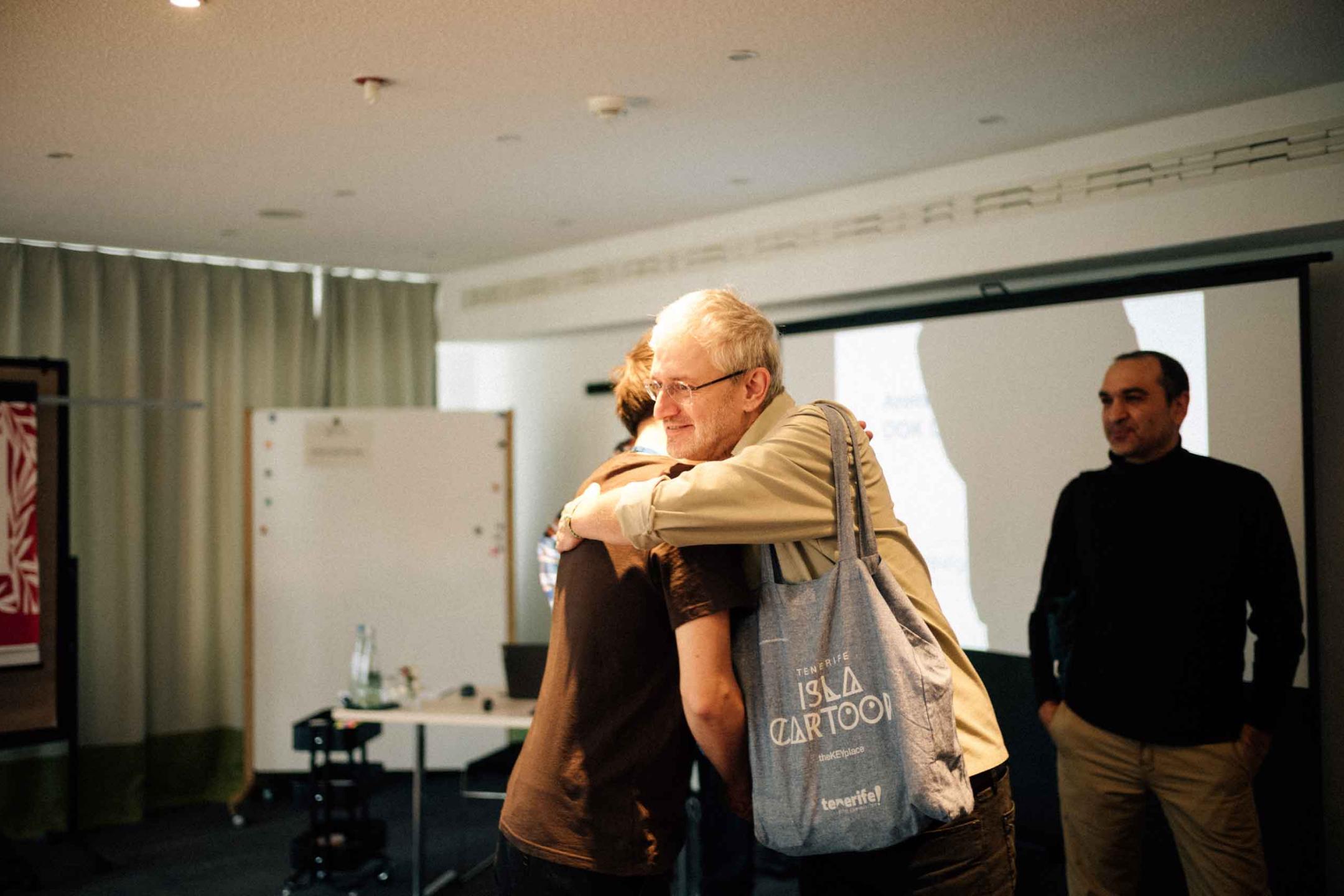 Producer Jean-François hugs a participant of the Animation Lab in the workshop space