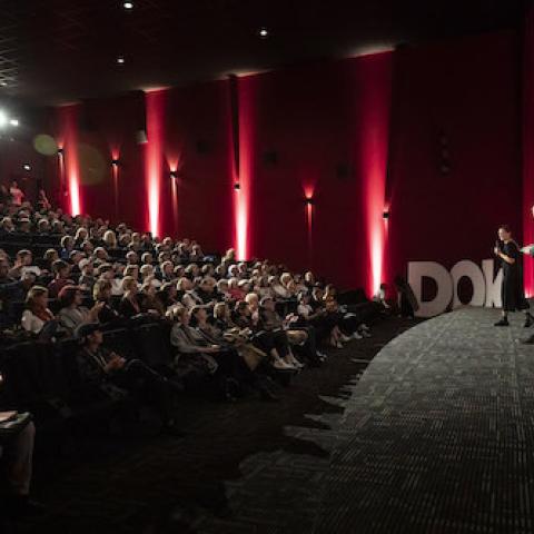 The picture of last year's festival opening shows the audience in the cinema hall, with the presenter on sta