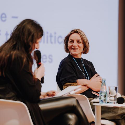 Two women are sitting on stage during a film talk