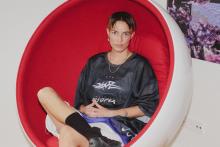 Portrait of Anan Fries sitting in a huge round red chair