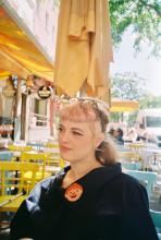 Portrait of Lauren Michiels sitting outside of a restaurant