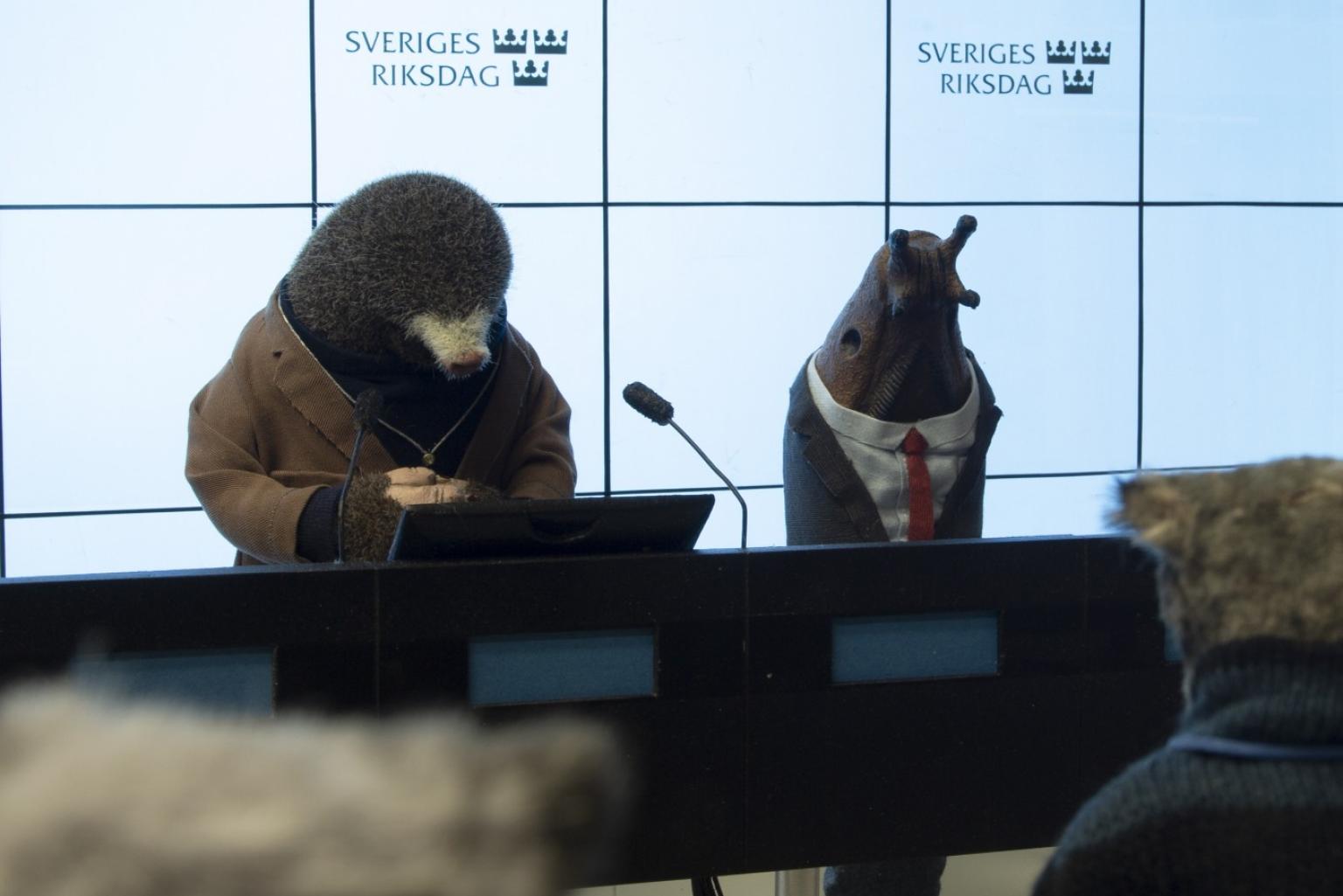 Animated mole and snail talk at a press conference