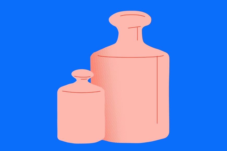 Two pink weights in front of a blue backdrop, the closer one is much smaller than the weight behind it
